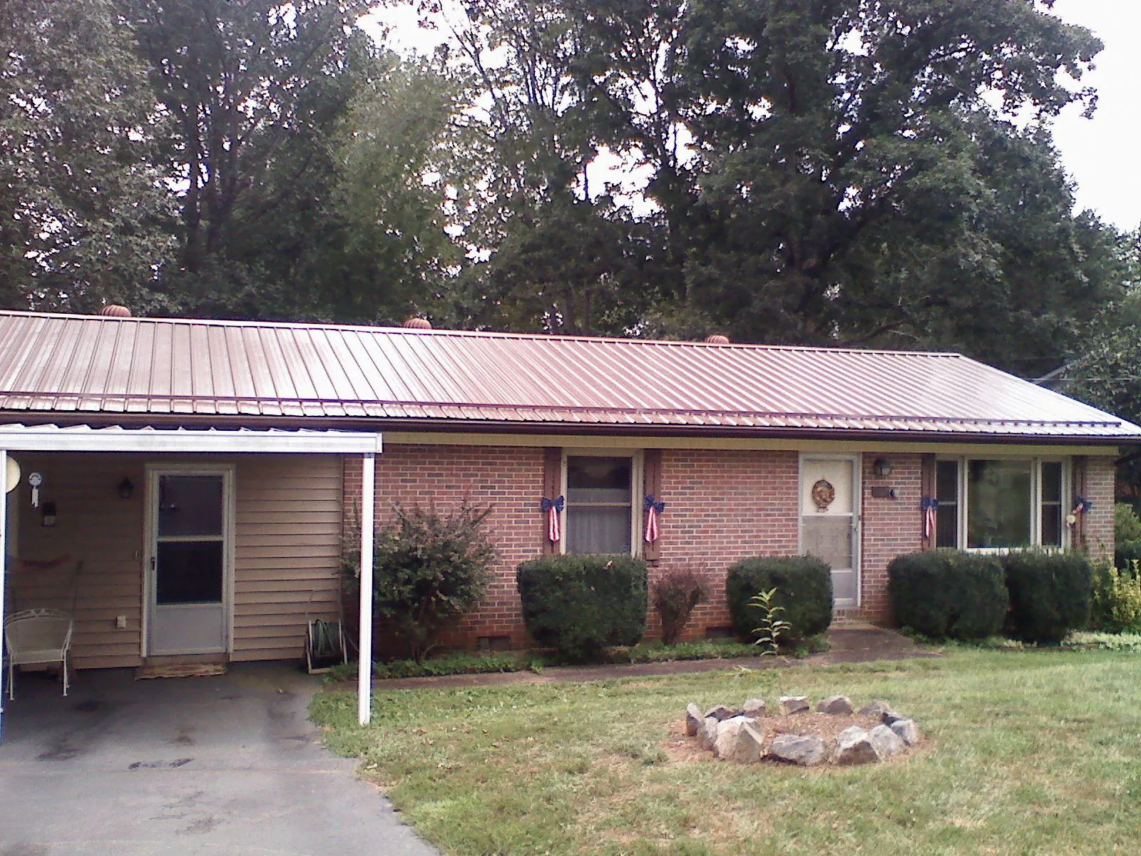 Bronze metal roof and carport on a brick ranch home — Roof Repair work by our crew in Oakley